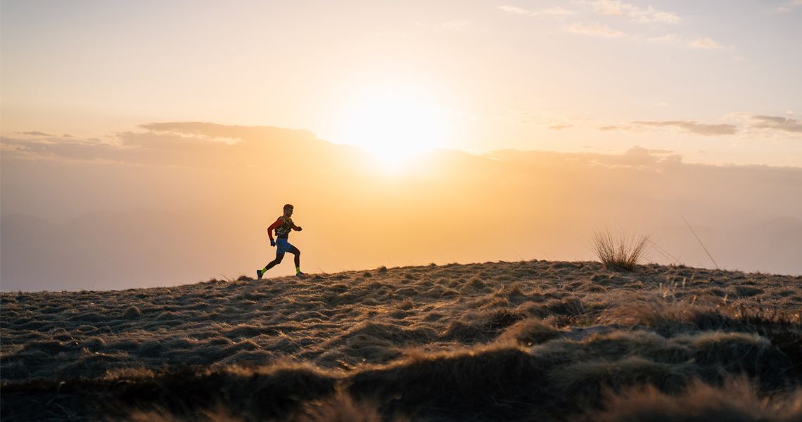runner in a field at sunrise